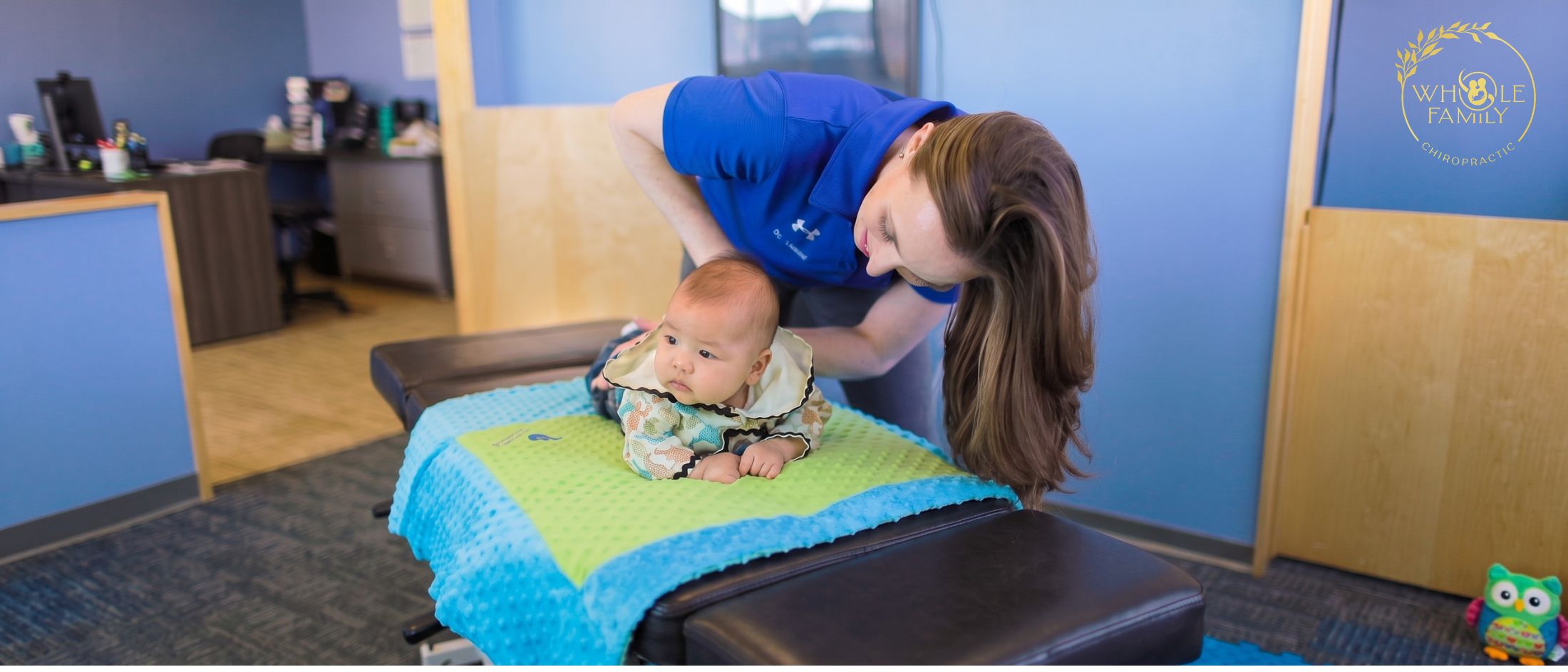 birth-trauma-baby-spine-chiropractic Pediatric chiropractor evaluating a baby's spine after birth trauma to support healthy spinal function and development.