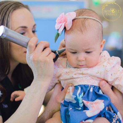 Dr. Jessica examining a newborn after birth trauma to assess spinal alignment and overall musculoskeletal function.