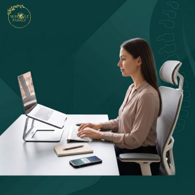 Person maintaining proper sitting posture at an ergonomic workstation to help stop slouching during computer work.
